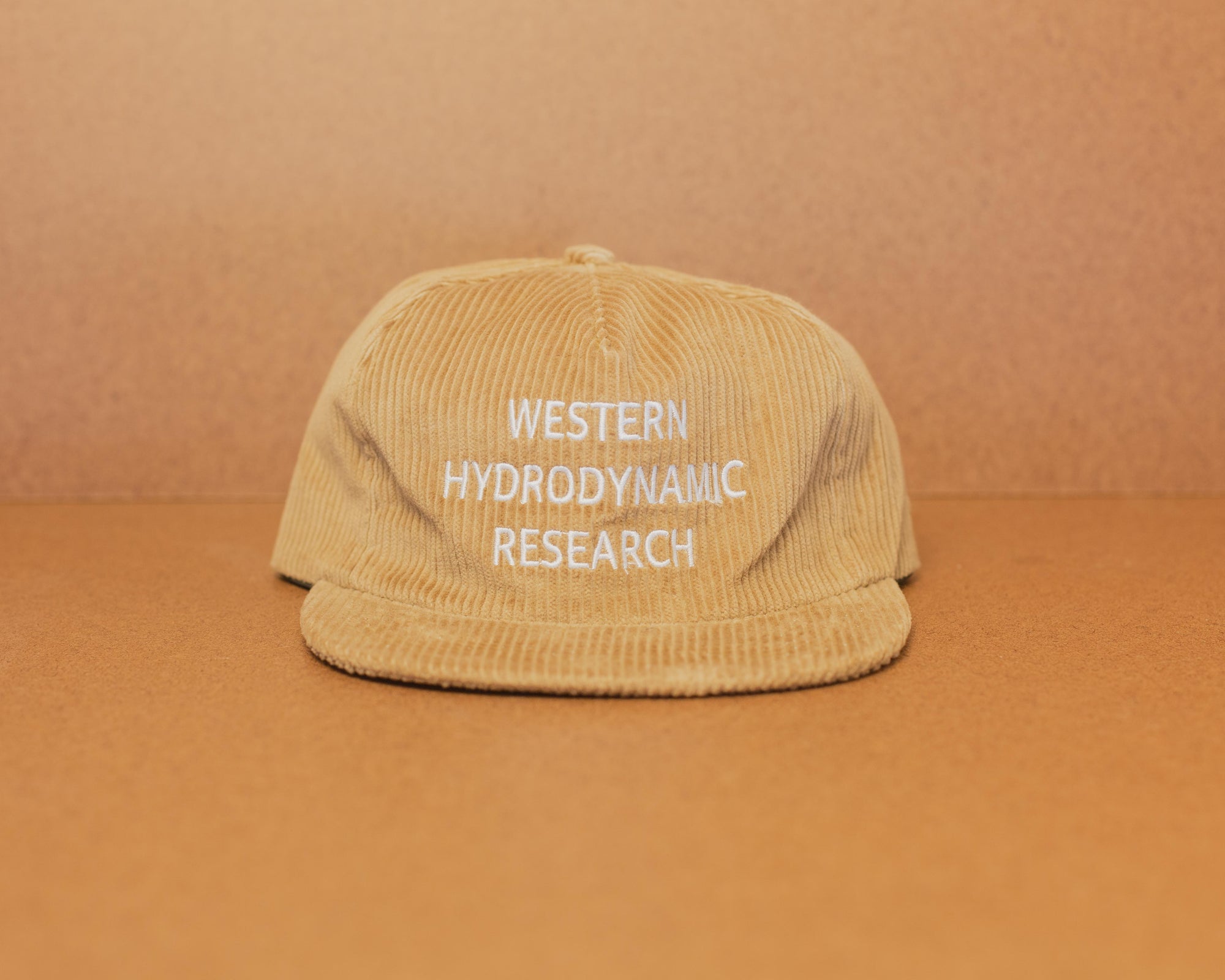 Western Hydrodynamic Research- Whale Cord Hat (Beige) front view brown background
