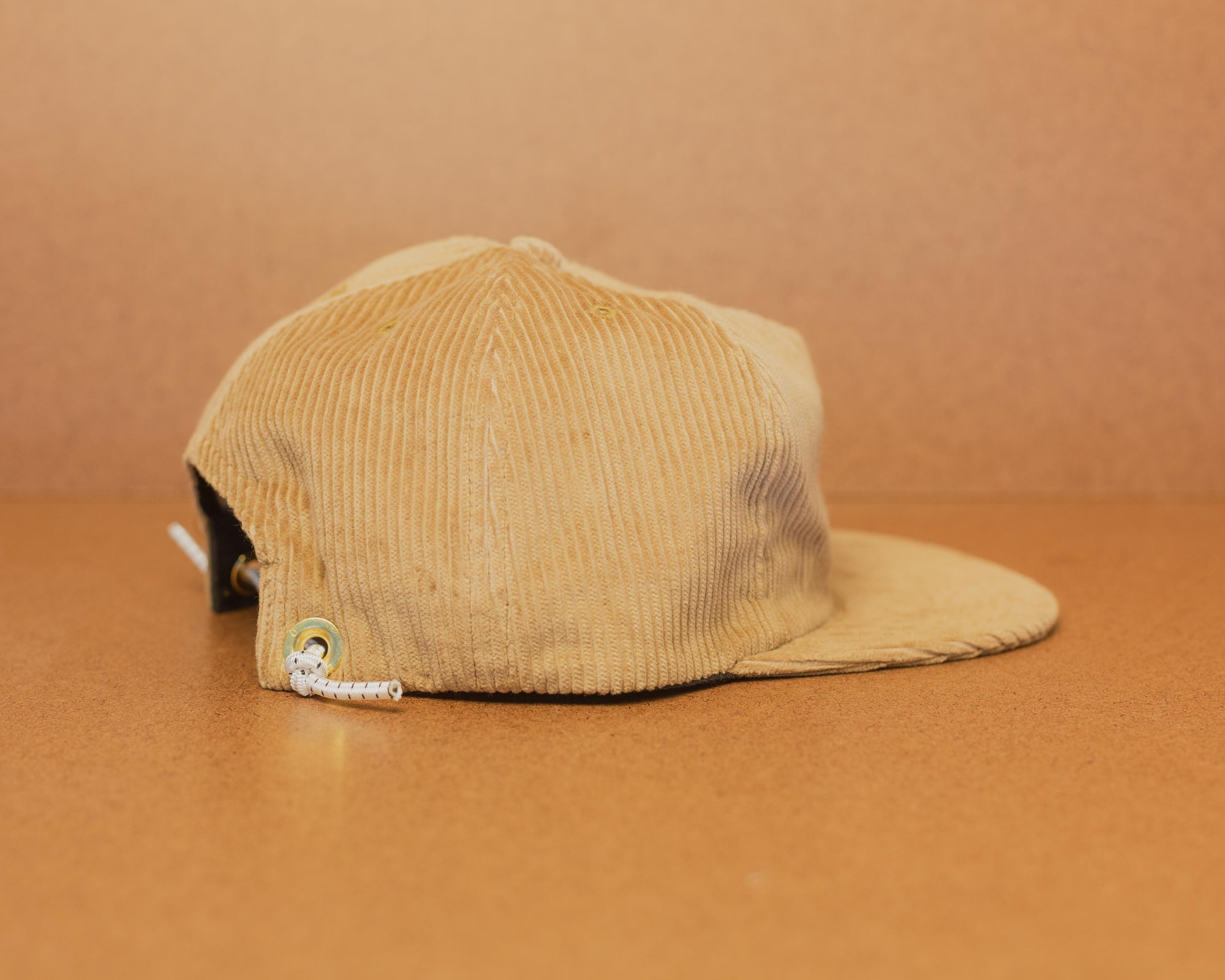 Western Hydrodynamic Research- Whale Cord Hat (Beige) side view brown background