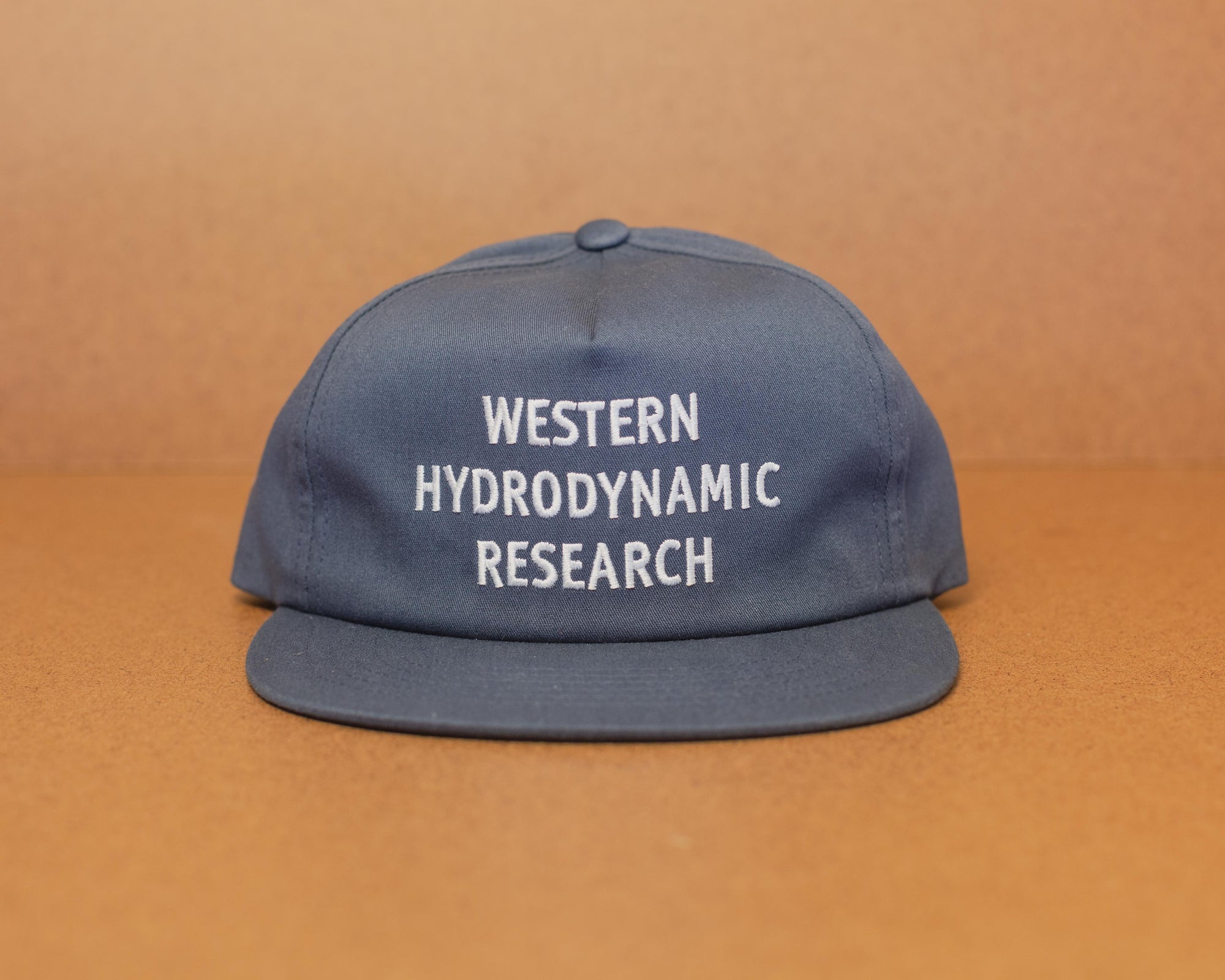 Western Hydrodynamic Research- Canvas Promotional Hat (Navy) brown background